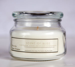 The Little Scent Shoppe Coconut Soy Wax Candle Our Scent of Bliss 9oz candle has clean yet earthy notes of:  Cardamom, Violet , Smoke and Sandalwood